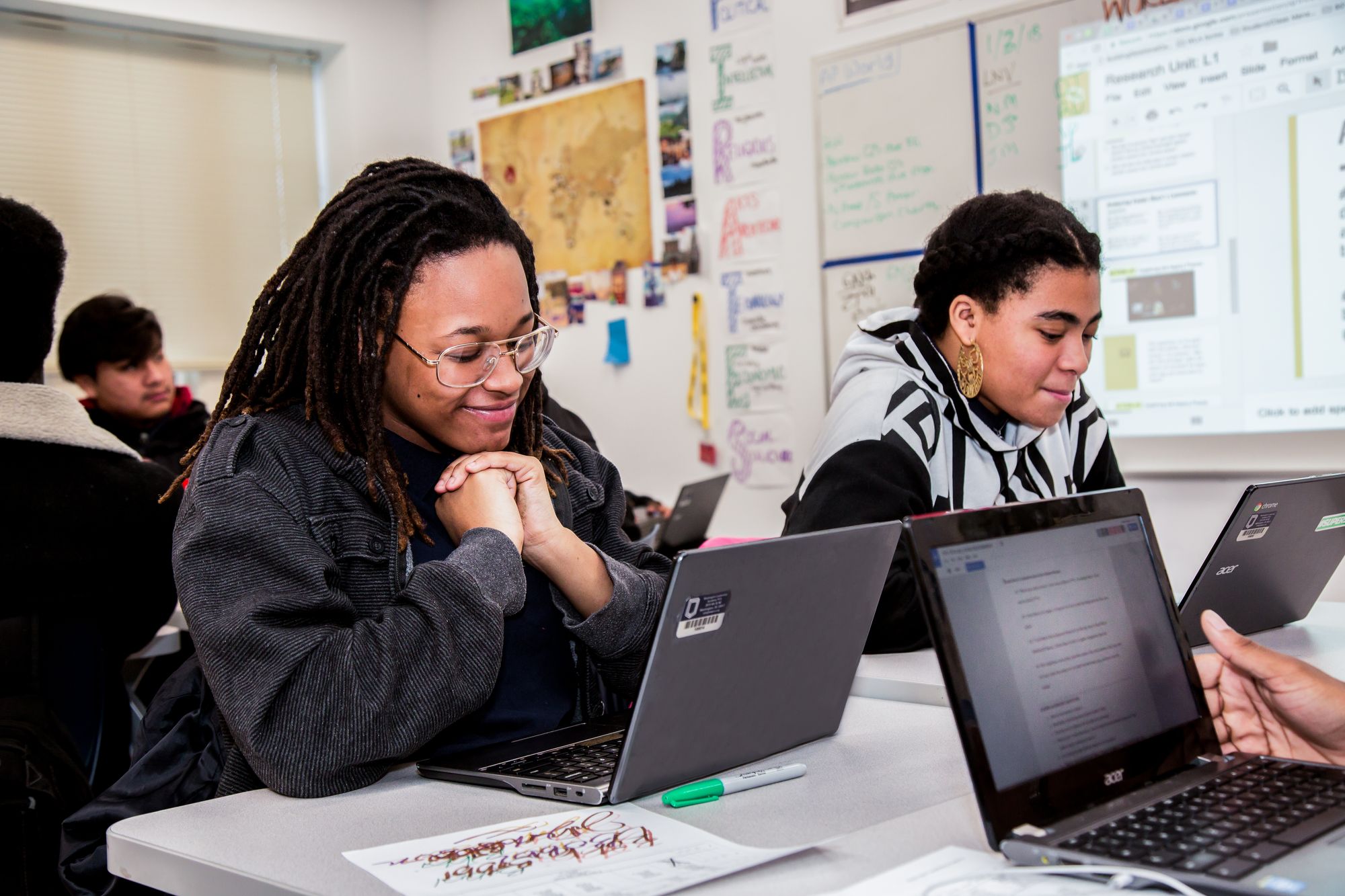 Two students read over a CommonLit lesson