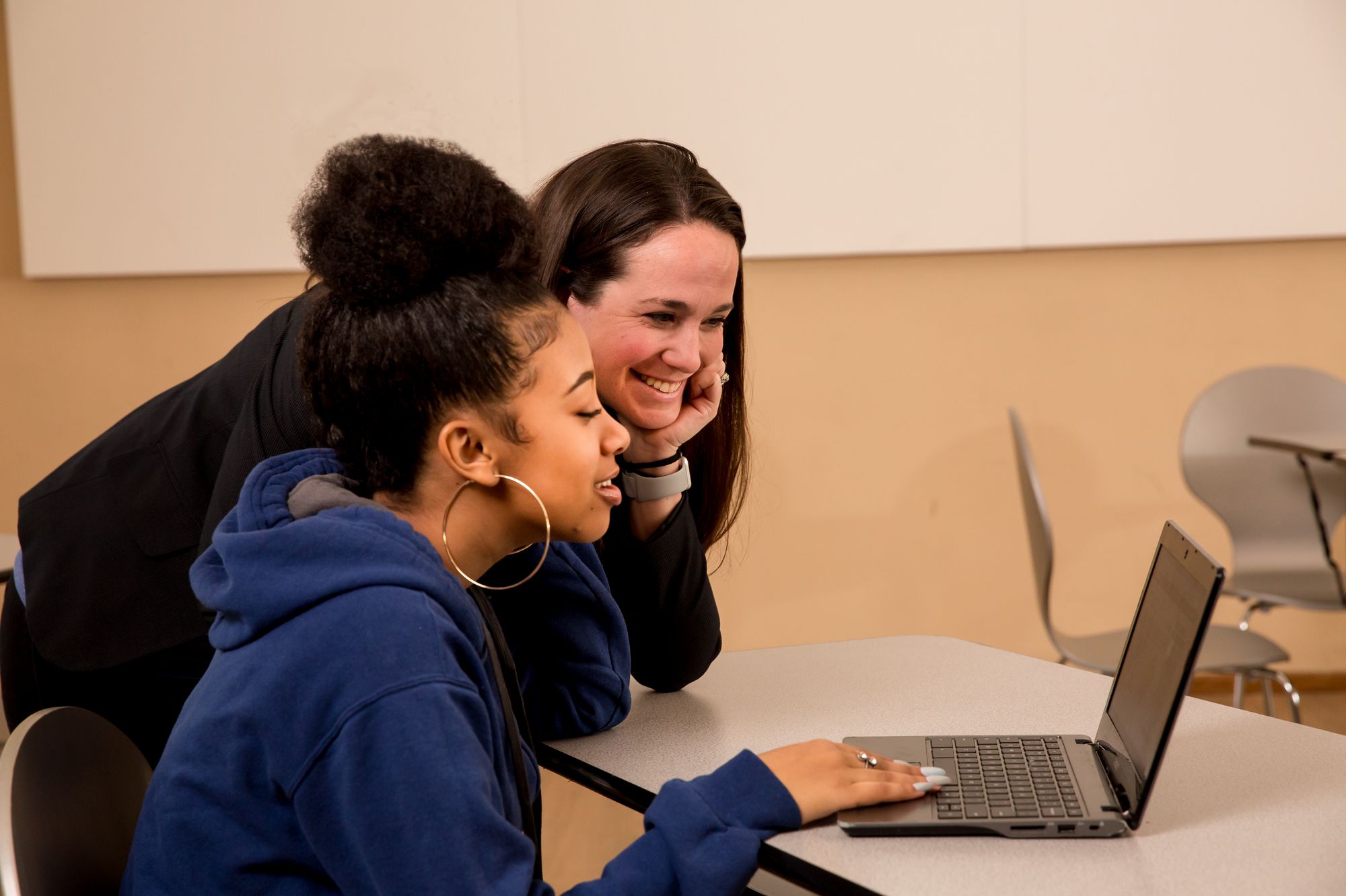 A teacher and student work on an online assignment together.