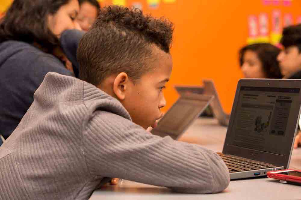 Student working on a CommonLit assignment on a laptop.