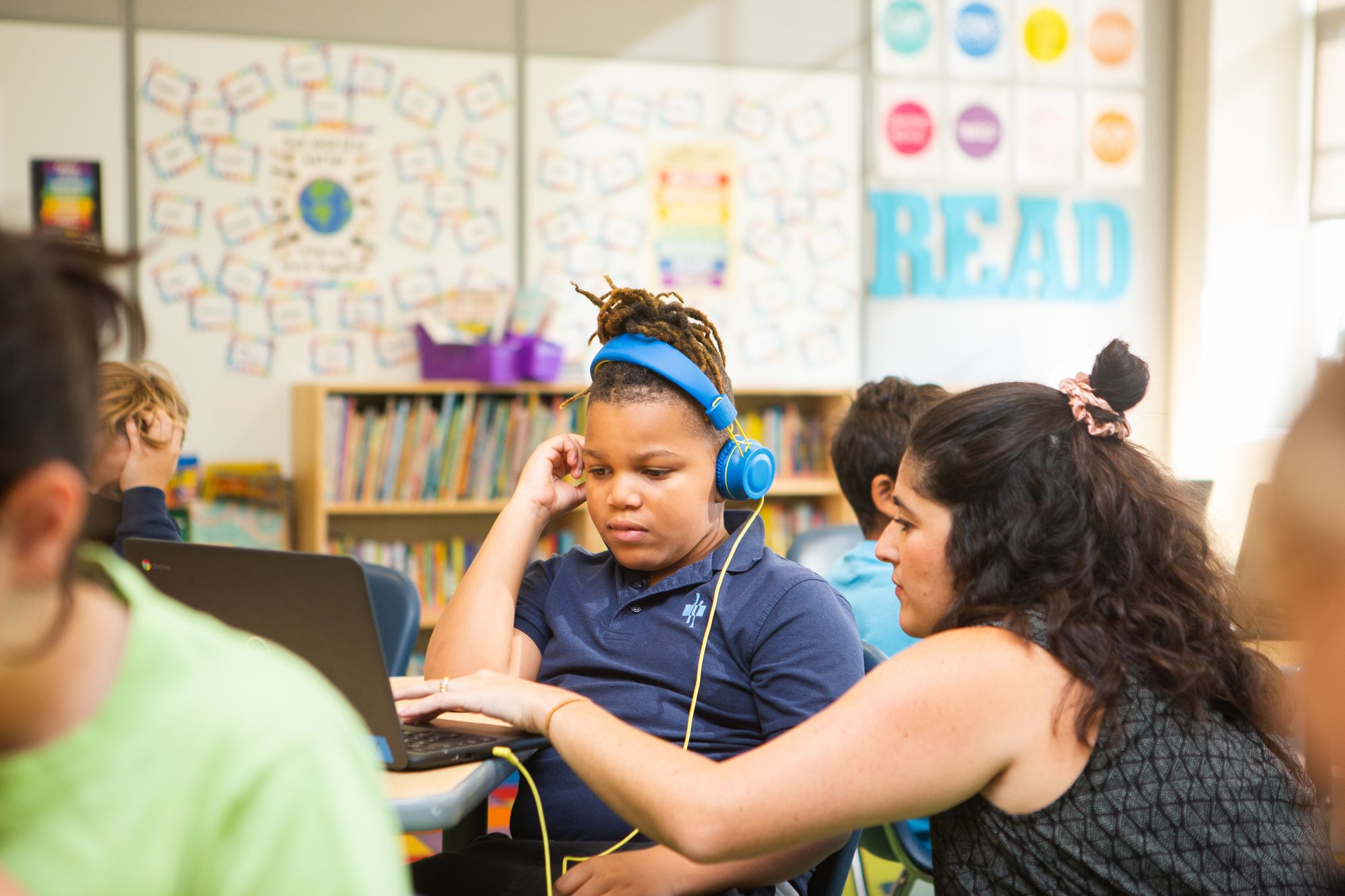 Teacher helps a student with a CommonLit 360 lesson.