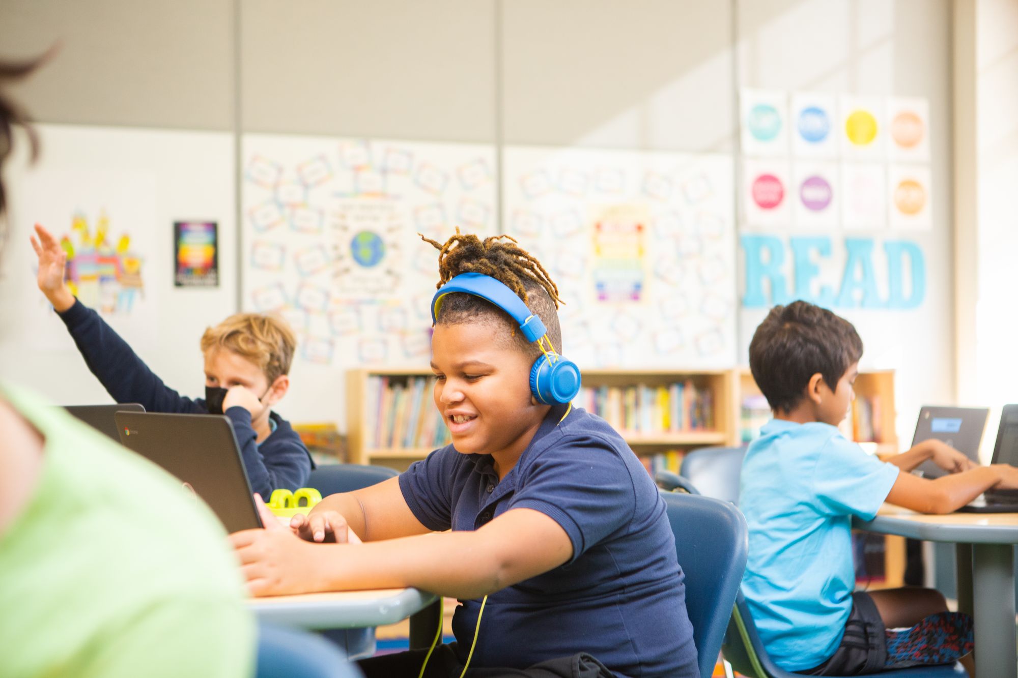 Elementary student listening to a digital CommonLit Original Story.