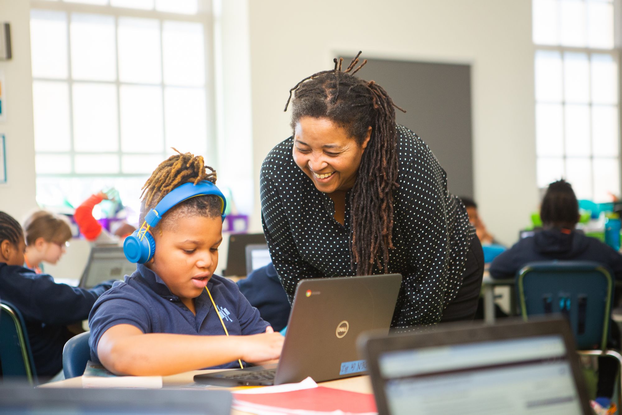 Elementary school children work on CommonLit digital reading comprehension lessons on their computers.