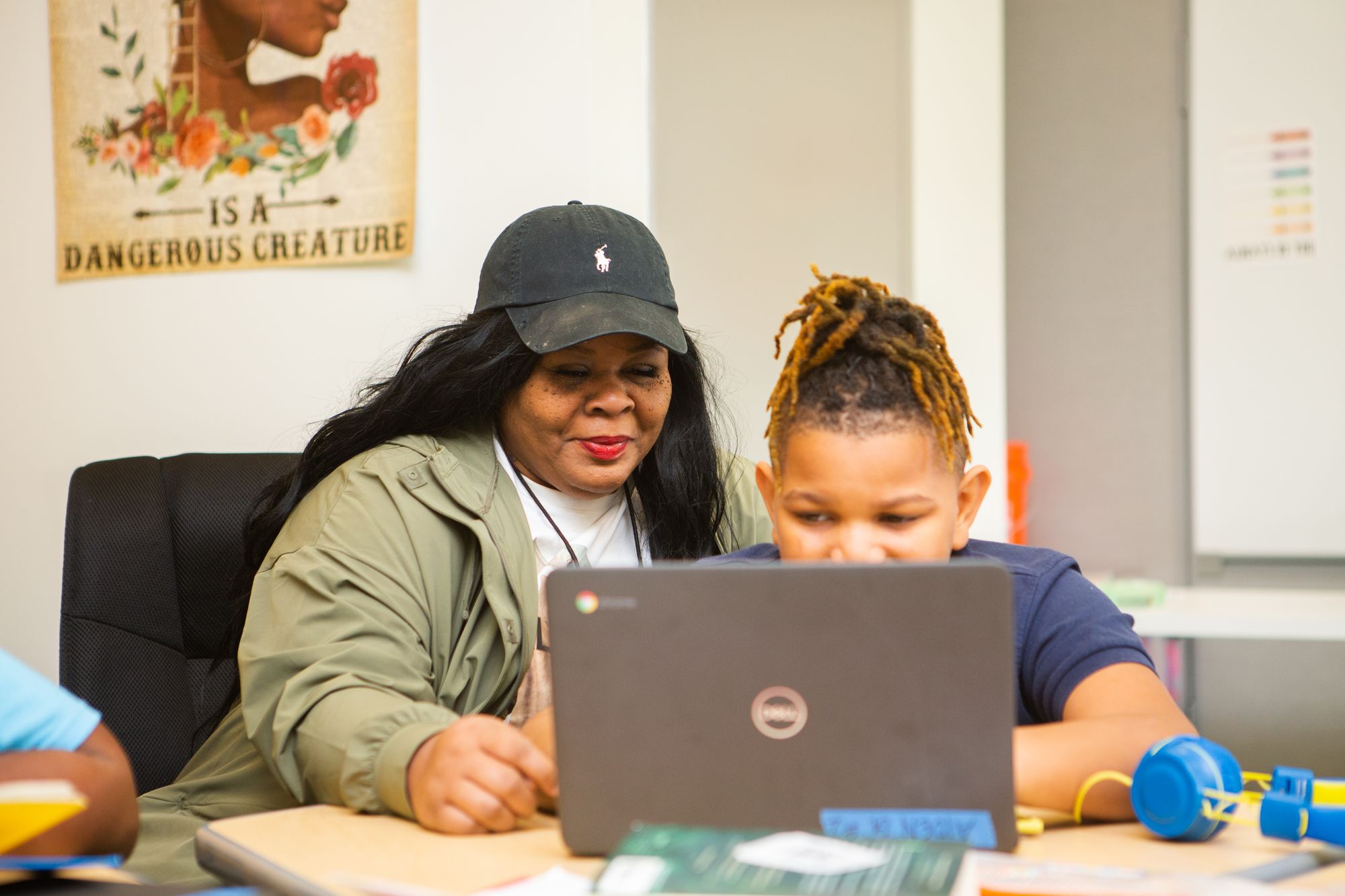 A teacher reviews data with a student.