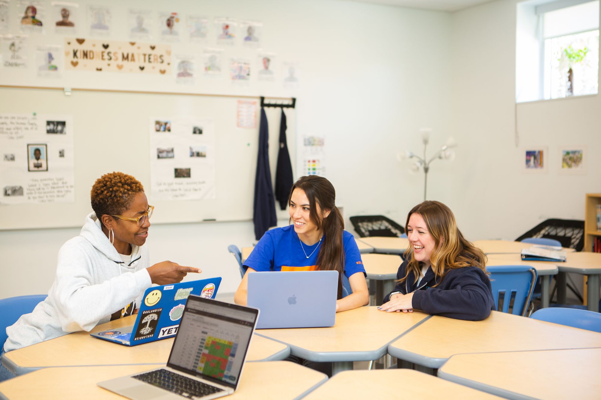 A teacher talks to students about a CommonLit lesson