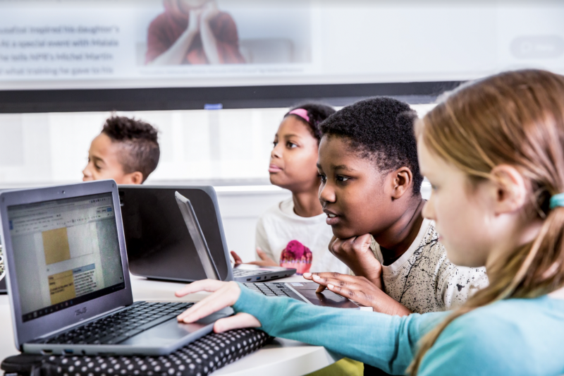 Young students looking at their computer screens. 