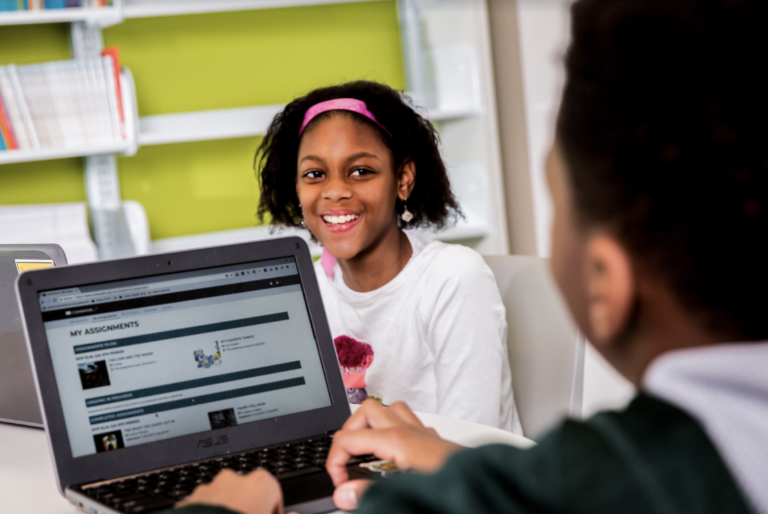 Student smiles while working on CommonLit lesson. 